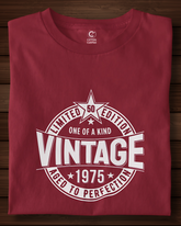 Folded red t-shirt with white graphic design on a wooden surface